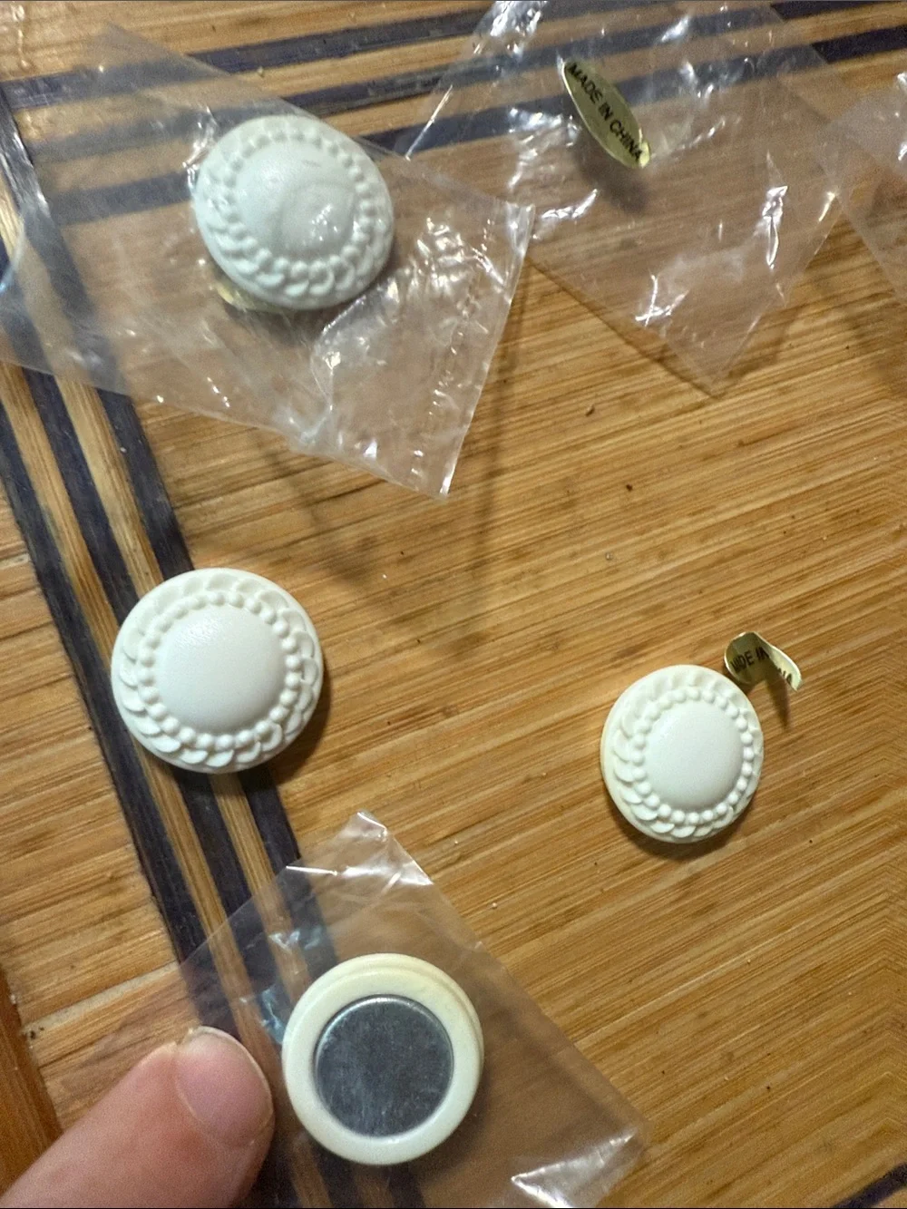 White Round Magnetic small, round, white decorative items that appear to be cab